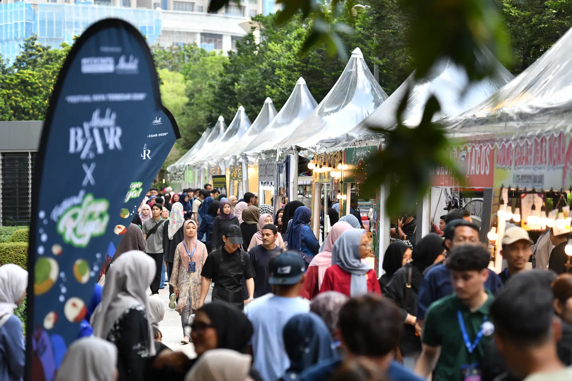 Visitors walking between the outdoor tents at the Kuala Lumpur edition